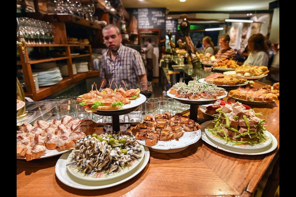 At Basque-style tapas bars, pintxos are already laid out, so you can simply point to or grab what you want.