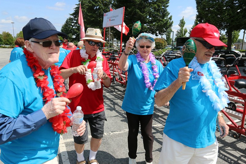 MARIO BARTEL/THE TRI-CITY NEWS
Brian and Barb Corbould, right, lead some of their team members from Mayfair retirement home, in a little warm-up dance prior to embarking on a ride on the Heart and Stroke Foundation's "big bike."