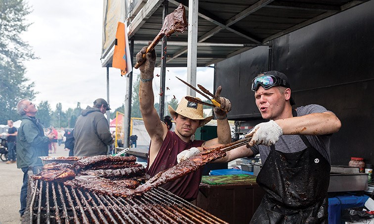 The crew from Misty Mountain BBQ use a little showmanship to sauce ribs on Sunday afternoon at Pacific Western Brewing on the last day of PG Ribfest. Citizen Photo by James Doyle