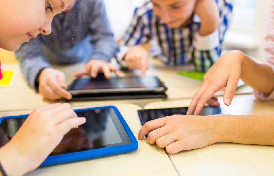 kids on iPads, stock photo, kids and technology