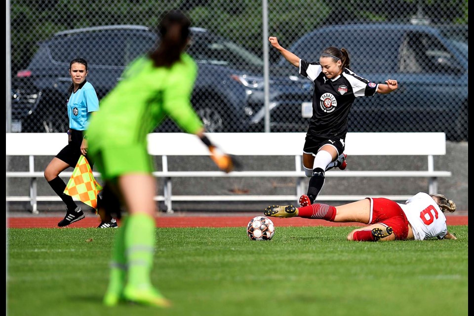 Burnaby's Christina Dickson, dodges a defender's sliding check during her team’s 2-1 win over the Westside Timbers at Burnaby’s Swangard Stadium.