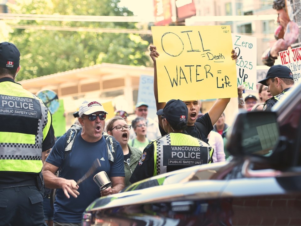 Protesters gather outside the Opus Hotel in Vancouver in May when Prime Minister Justin Trudeau came