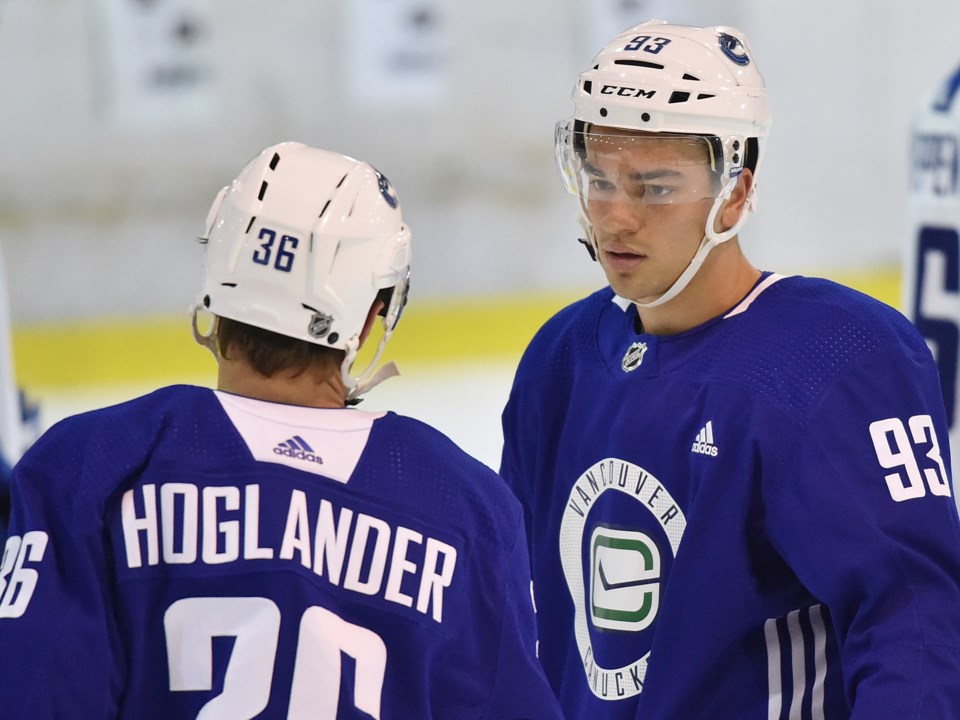 Darien Craighead talks to Nils Hoglander at Canucks 2019 development camp.