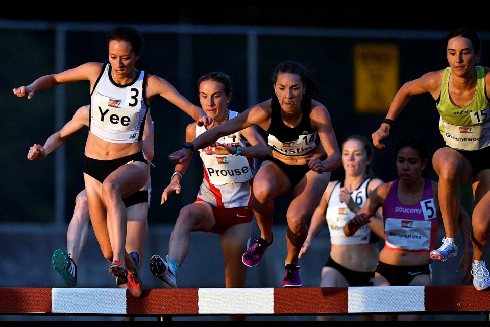 Regan Yee climbs the steeple in pursuit of an IAAF world qualifying time at the Harry Jerome Track Classic last Thursday in Burnaby. Yee overcame a 10-metre deficit to win the 3000m women's steeplechase event, but fell just six-one-hundreds of a second shy of the mark.