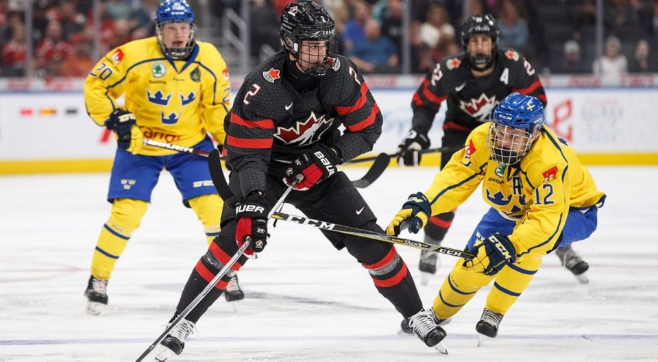 Arvid Costmar of Sweden moves to check Justin Barron of Team Canada.