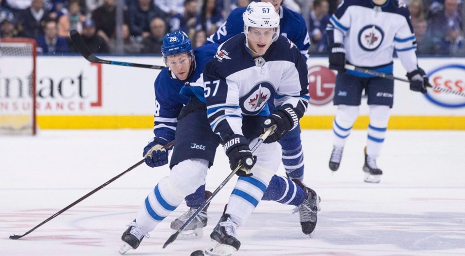 Tyler Myers carries the puck for the Winnipeg Jets.