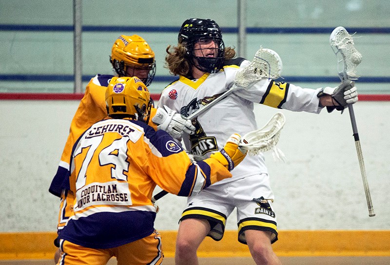 Port Coquitlam Saints forward Jack Hamilton is checked by a Coquitlam Adanacs defender Ethan Ticehurst and Luca Antongiovanni in their BC Junior A Lacrosse League game, last Friday at the PoCo Rec Centre.