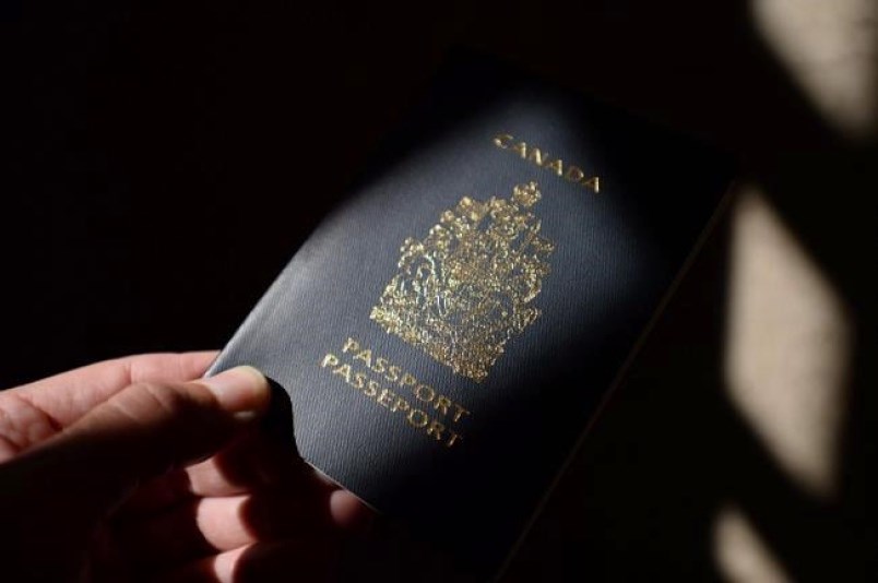 A Canadian passport is displayed in Ottawa on Thursday, July 23, 2015.