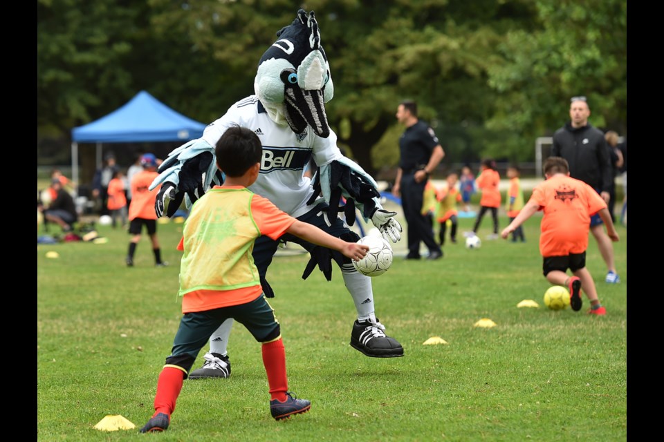 Vancouver Whitecaps FC mascot Spike helps run drills at the 30th annual VPD Youth Soccer Camp at Strathcona Park. Photo Dan Toulgoet