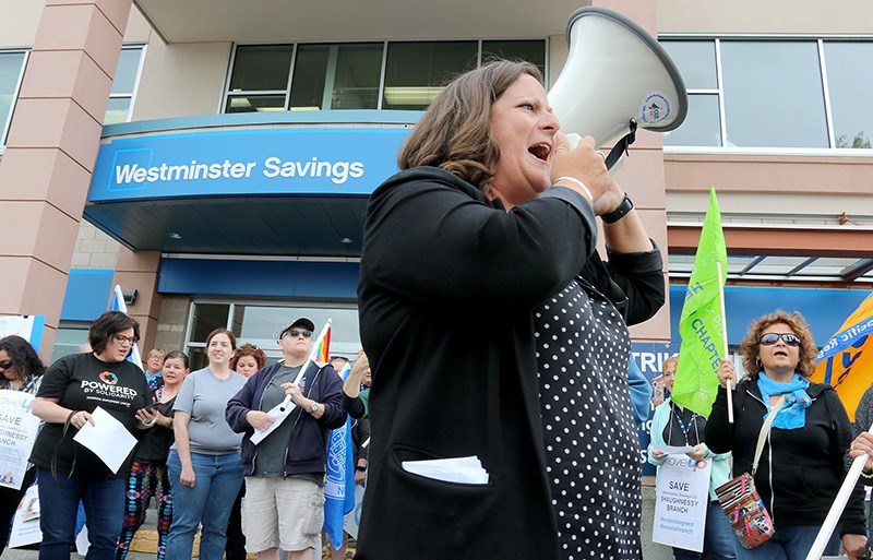 Sussanne Skidmore, secretary-treasurer for the B.C. Federation of Labour, leads chants supporting unionized workers rallying at the Westminster Savings branch in Port Coquitlam that has been behind a picket line since Jan. 22. The credit union recently announced its intention to close the branch in the fall.