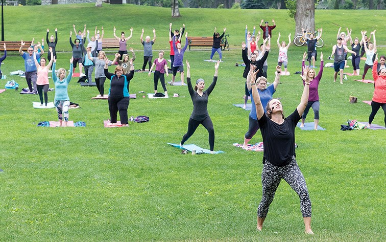 Jaylene Pfeifer, co-owner of Chinook Yoga, leads roughly one-hundred yoga enthusiasts at Lheidli T’enneh Memorial Park on Sunday morning during the first summer session of the yoga studio’s ninth season of Yoga in the Park. Citizen Photo by James Doyle
