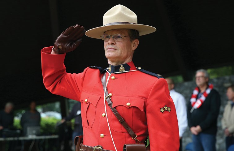 Const. Trevor Hurley salutes as the national anthem is played on Monday at Lheidli T'enneh Memorial Park during Canada Day festivities. Citizen Photo by James Doyle