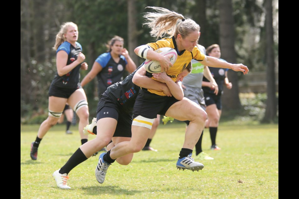 Christina Burnham of the Capilano Rugby Club’s premier women’s team fights past a tackler during a matchup against Westshore earlier this season. The Caps will take part in the first ever Canadian Rugby Club Championship women’s tournament next month in Toronto. photo Kevin Hill, North Shore News