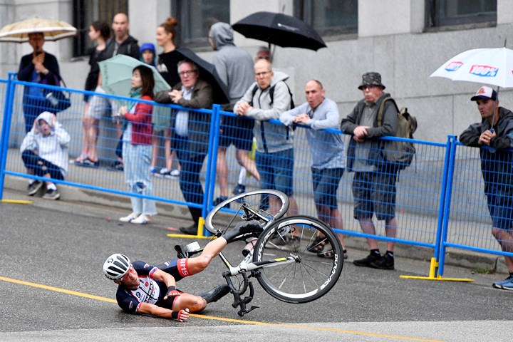 Fans react as a Kaler Marshall of Walla Walla, Wash., crashes during one of Tuesday night’s wet Grand Prix races in downtown New Westminster. This race is considered by some as the toughest of the Superweek races due to our city’s hills - both for the climb up and the speeds riders reach while coming down. JENNIFER GAUTHIER PHOTO