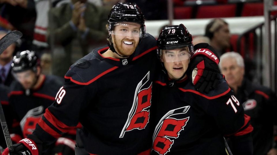 Dougie Hamilton celebrates a goal with Micheal Ferland of the Carolina Hurricanes.