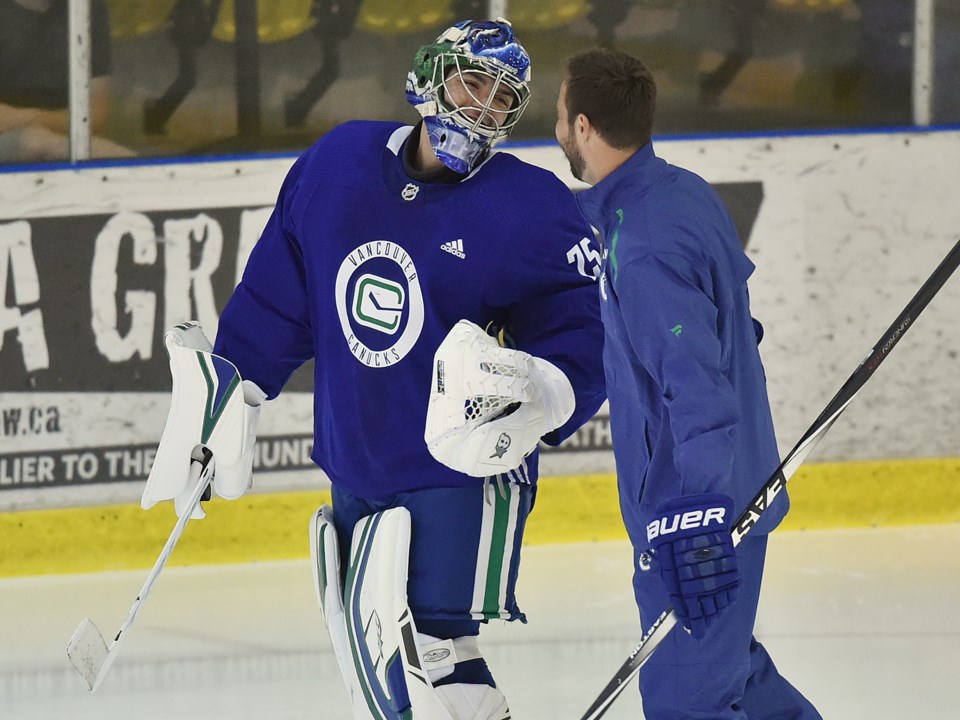 Michael DiPietro shares a laugh with former-Canuck Chris Higgins at Canucks 2019 Development Camp.