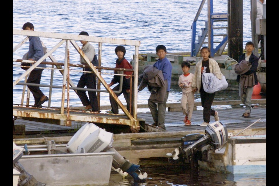 The last of the illegal migrants take the ramp to buses in Port Hardy on Aug. 12, 1999, for the trip to Esquimalt.