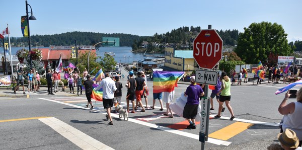 A crowd of more than 100 rallied at the Five Corners in Gibsons Saturday after the Town’s new rainbow crosswalks were vandalized.