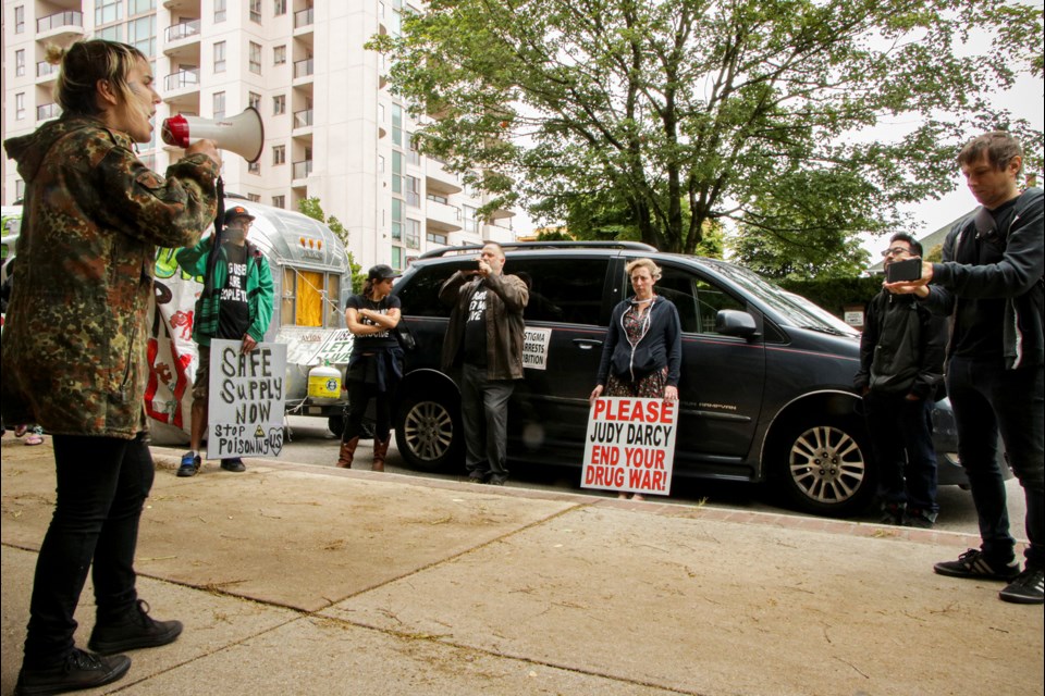 Protester Eris Nyx takes a turn on the microphone at the Occupy For Safe Supply rally outside New West MLA and Mental Health and Addictions Minister Judy Darcy.