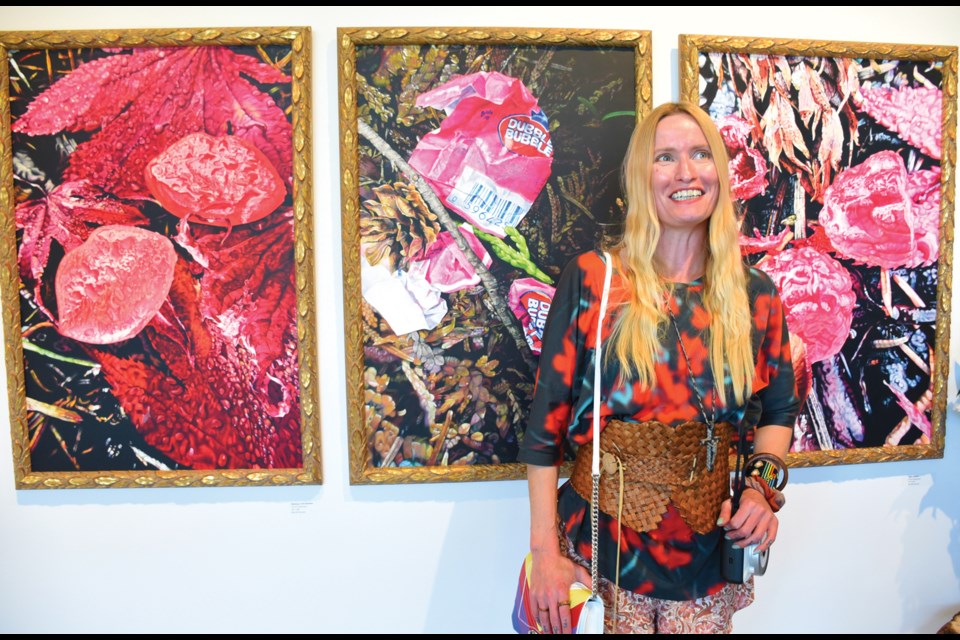 Caroline Weaver poses at The Kube gallery with some of the paintings from her show, Neon Brown.