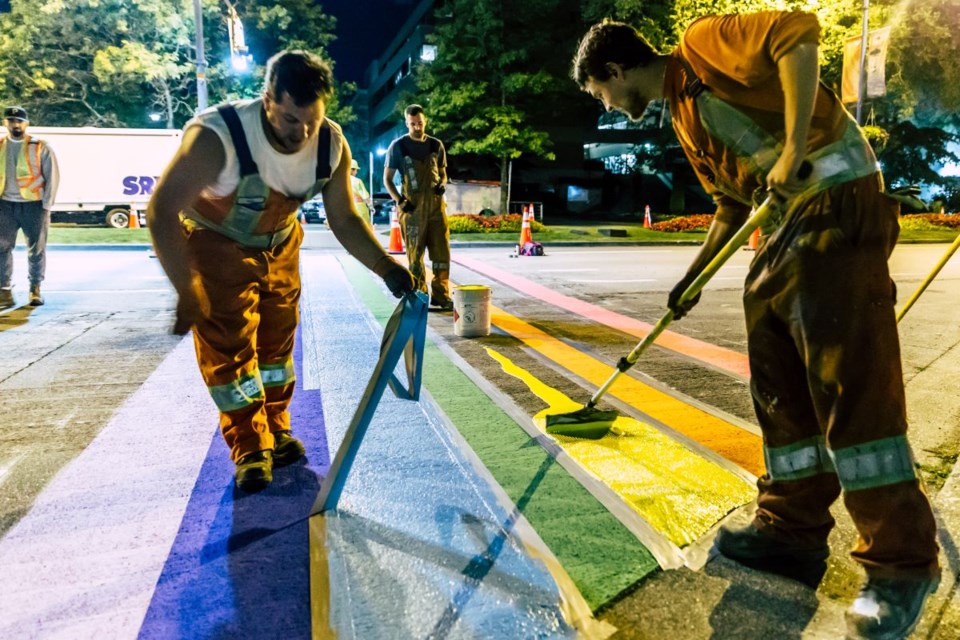 Workers painting the last couple stripes of the rainbow crosswalk at 12:30 a.m. on Sunday. Herb Chao photo submitted
