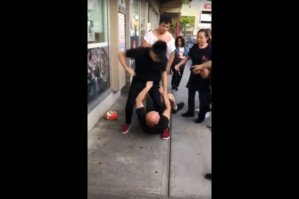 The restaurant owner was pushed on the ground, and the customer was trying to hit him in the head. Screenshot