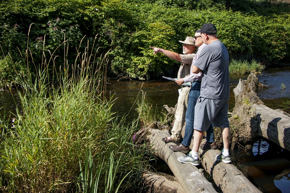 Vic Leach (left) with New Westminster Environmental Partners points out part of the proposed route of the TransMountain pipeline expansion to New West-Burnaby MP Peter Julian and Burnaby Mayor Mike Hurley (right).