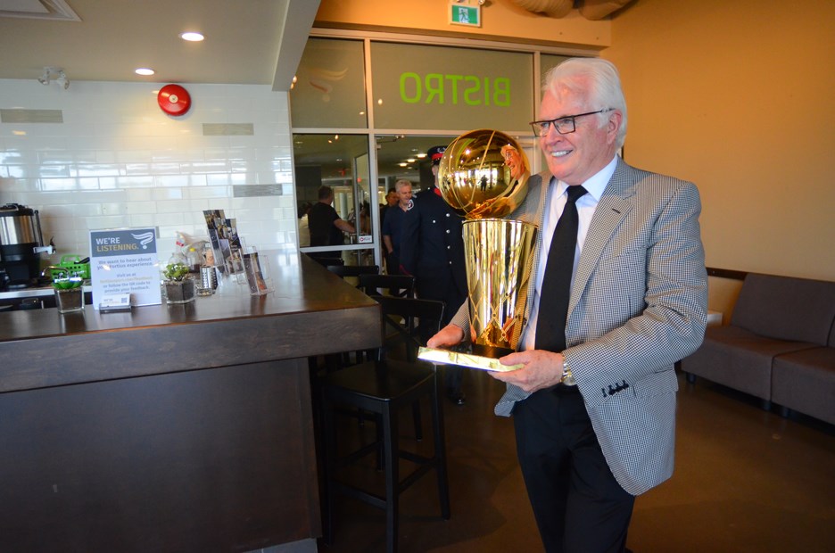Alex McKechnie carries the trophy into the Game Changers Bistro at Fortius Sport & Health. PHOTOS CORNELIA NAYLOR