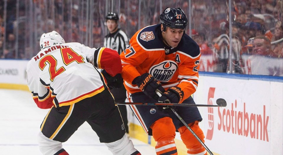 Edmonton Oilers' Milan Lucic skates past Travis Hamonic of the Calgary Flames.