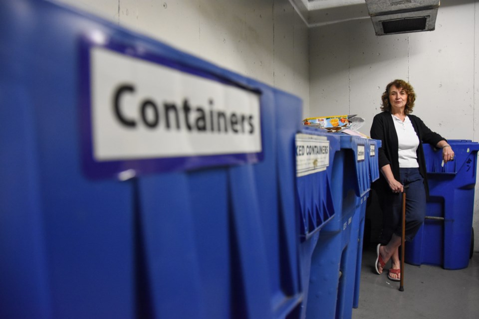 The garbage room at The Madison, where Claudette Friesen lives, has bins for plastics, paper, cardboard, trash, organics and even styrofoam.