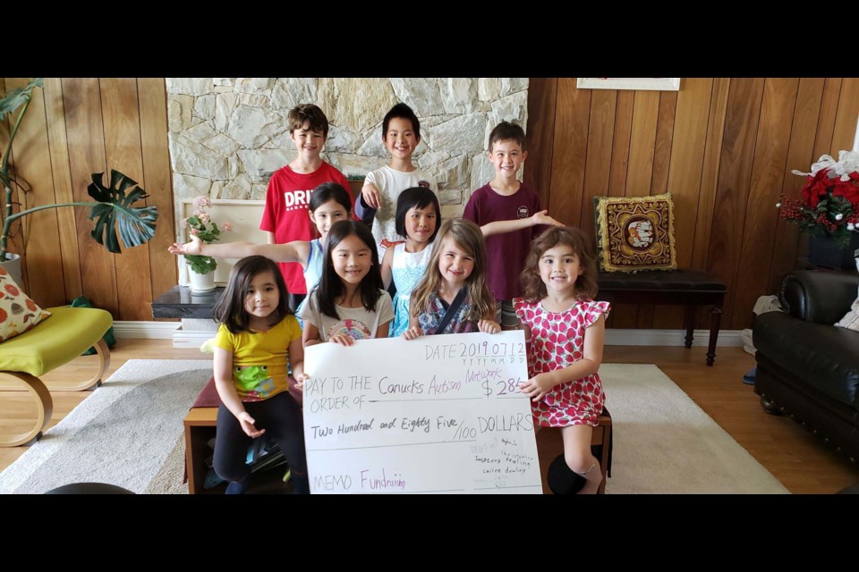 Two siblings, Bryan Zeng (rear, centre) and Ivy Zeng (middle row, right), along with their friends, raised $285 for Canucks Autism Network (CAN) from a yard sale this month. Their biggest revenue came from plants, followed by door-to-door cherry sales and a fundraising celebration party. Photo submitted