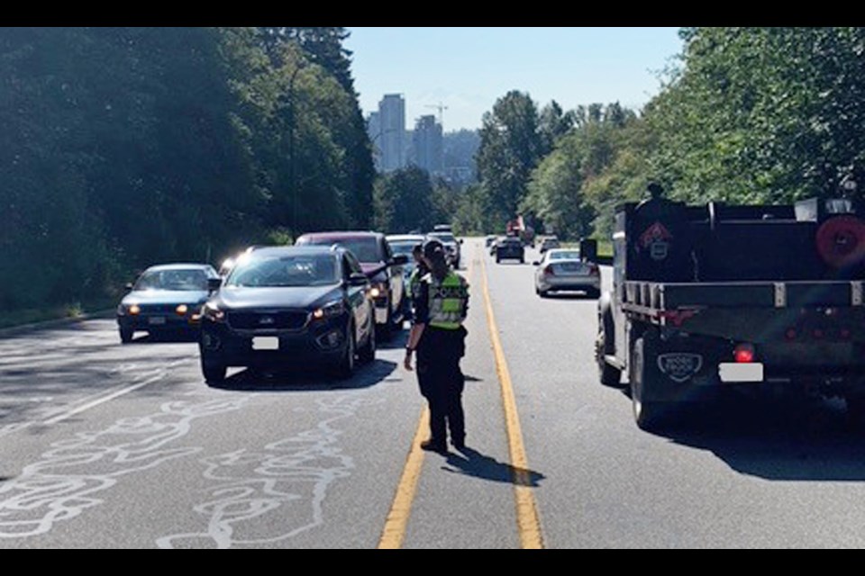 Police pull over vehicles at a check stop on Gaglardi Way Friday morning.