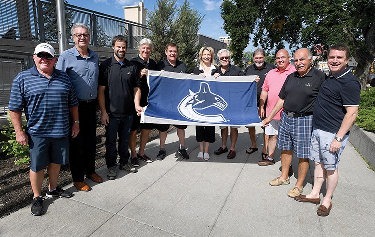 Vancouver Canuck alumni, Commonwealth Cup organizers and sponsors along with the Mayor gathered at Prince George City Hall Monday morning to raise a flag as a way to thank the Canucks for their contributions to the community while also receiving an official proclamation that July 22 and 23 would be Vancouver Canucks Day in Prince George. Alumni will be playing in the Commonwealth Cup at Aberdeen Glen Tuesday. Citizen photo by Brent Braaten