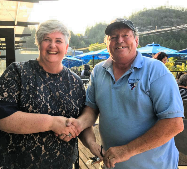 Peter King hands the keys of the express bus to Kate Coffey of Bowen Transportation Society.