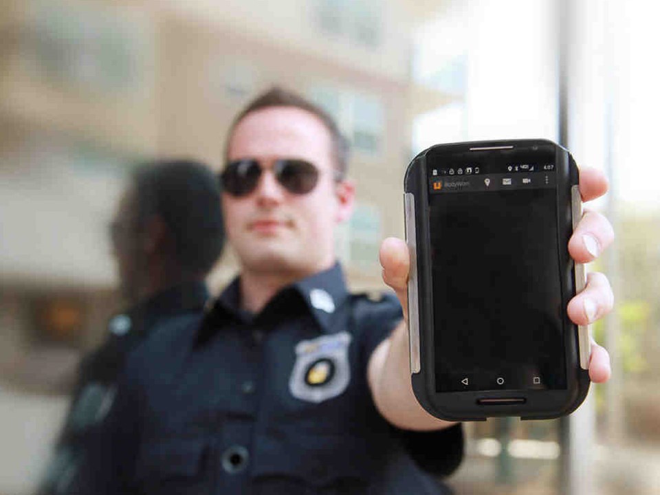 Police officer with cell phone