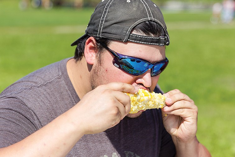 Corey Bolen chows down on a cob of corn during a corn eating contest on Monday afternoon at Huble Homestead during the historic site’s annual Homestead Days. Citizen Photo by James Doyle