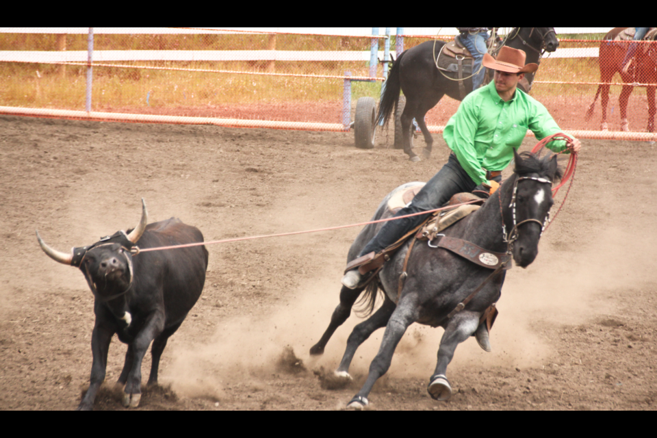 Wade Roberts successfully does his half of the job in the team roping event at the Doig River Rodeo on August 3, 2019. His brother Tyrel would rope the calf’s heels seconds later.