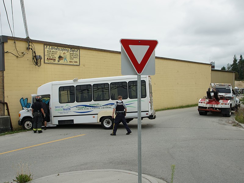 A small bus left the road on Duncan Street in Powell River on Friday, August 9, and crashed into a wall after having caused damage to two local businesses. Paul Galinski photo