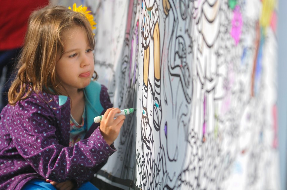 Kamila Bohorquez, 4, colours in a community mural at the 2019 Kaleidoscope Art Festival in Coquitlam