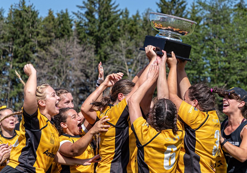Members of the Capilano premier women's team hoist the national championship trophy following their win in the inaugural Canadian Rugby Club Championship tournament. photo Jeff Chan