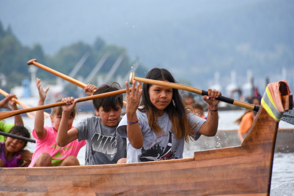 The Spirit River Canoe Club from the Skwah First Nation paddle in a six-person canoe heat.