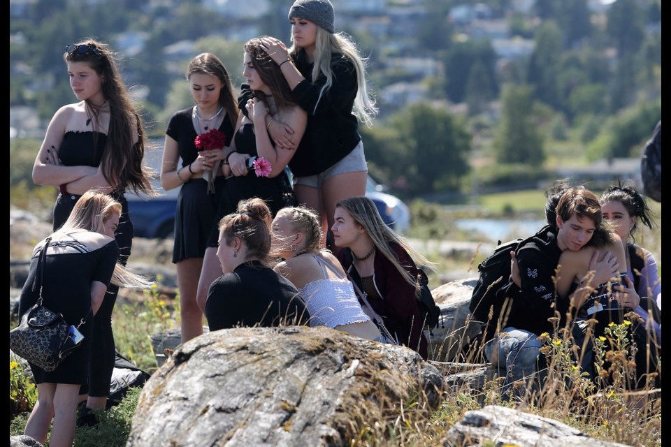 Relatives and friends of 16-year-old Abby Barker pay tribute at Esquimalt Lagoon with flowers, hugs and messages in bottles floated out to sea on Wednesday. The Langford teen died from what her family said was a drug overdose. Aug. 14, 2019