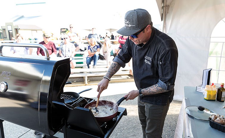 Shaun O’Neale, season 7 winner of MasterChef, stirs his garlic and mushroom risotto during a BBQ demonstration on Friday afternoon at the 107th BCNE. Citizen Photo by James Doyle