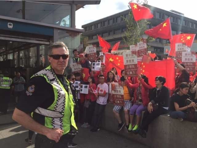 Pro-Beijing demonstrators were at the Broadway-City Hall Canada Line station in Vancouver, chanting slogans and waving flags and signs Saturday