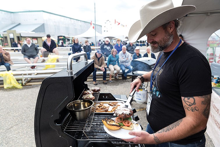 Kurt Flesher loads a burger onto a bun on Sunday afternoon at the 107th BCNE while competing in the final round of the first ever BCNE BBQ Cook-Off. Citizen Photo by James Doyle