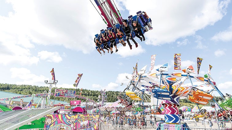 Riders on Frenzy fly high above the midway on Friday afternoon during the 107th BCNE. Citizen Photo by James Doyle