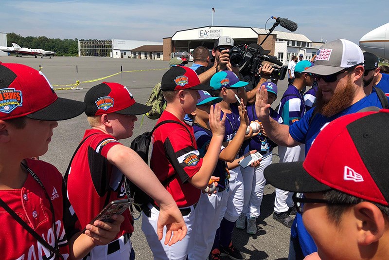 SUBMITTED PHOTO
Coquitlam's Little Leaguers, representing Canada, greet players from the Chicago Cubs arriving at the Williamsport airport for Sunday's special Little League Classic between the Cubs and Pittsburgh Pirates.