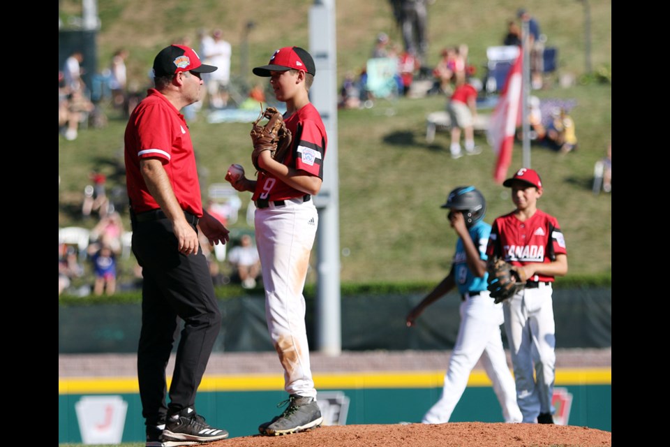 Canadian manager Bruce Dorwart lifts starting pitcher Timothy Piasentin from the mound after the hurler reached the mandated 85-pitch limit in Monday's Little League World Series game against Curacao. Canada lost 8-1 and is eliminated from the 16-team tournament.