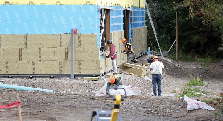 Crews work on the new Kelly Road Secondary School on Wednesday morning. Citizen Photo by James Doyle