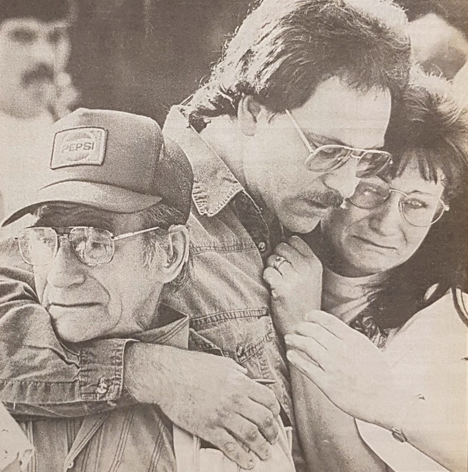 David Niven, brother of the slain man, is comforted by other relatives outside the Port Coquitlam co